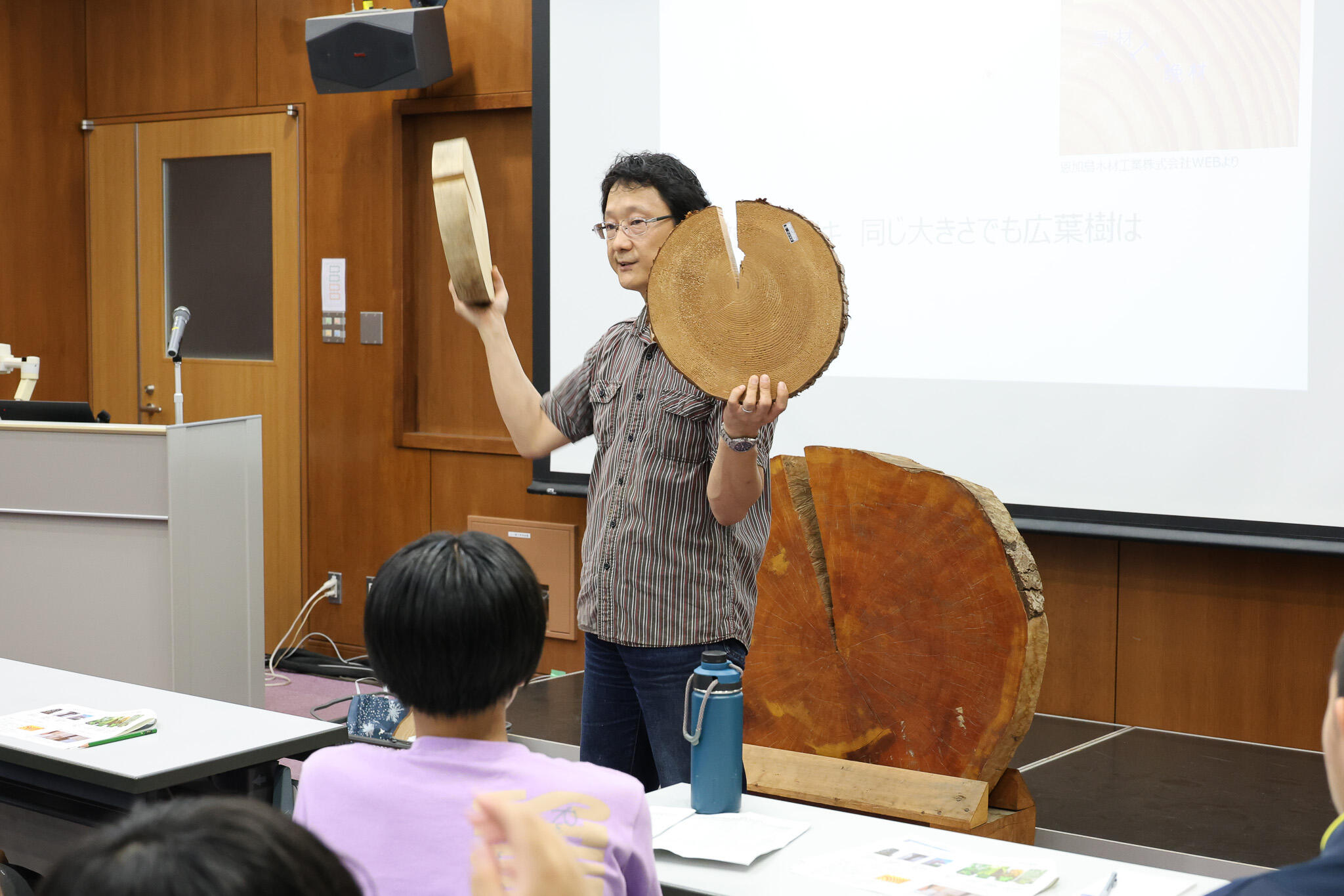 切り株を手に講義を行う中路教授（撮影：広報・コミュニケーション部門　川本 真奈美）